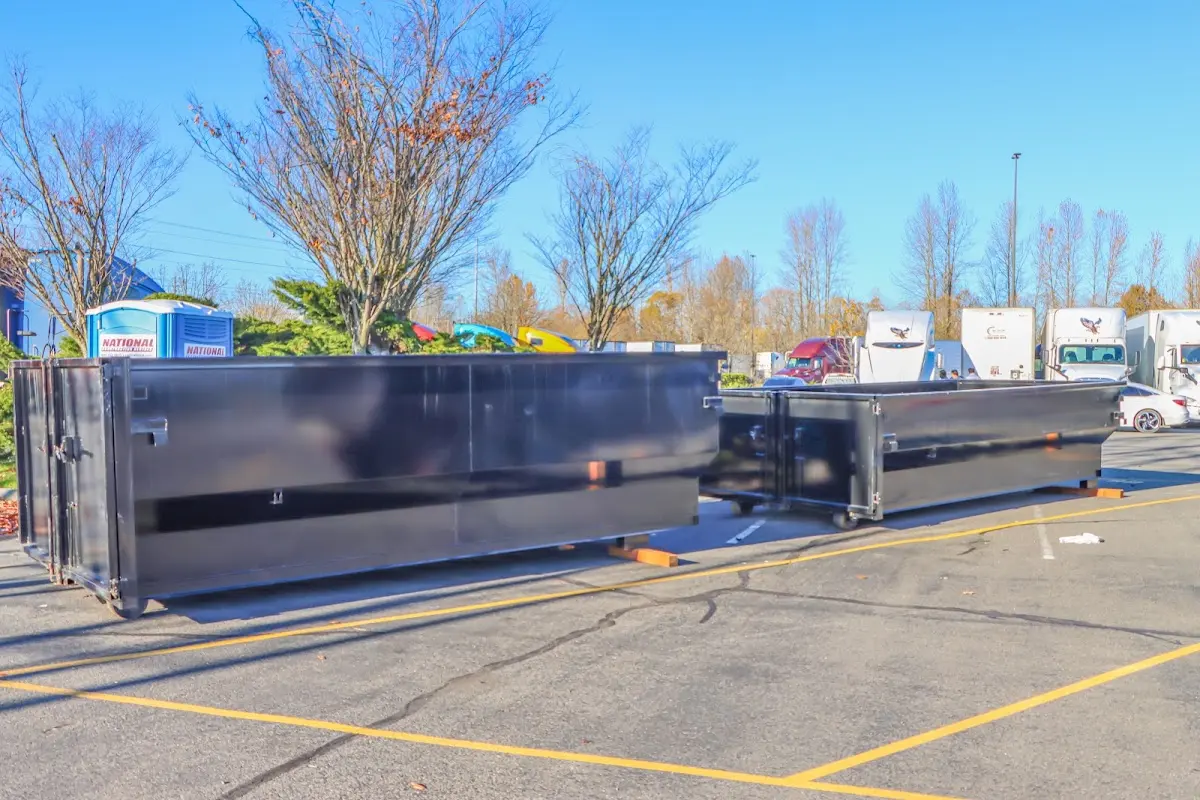 Professional dumpster rental service with roll-off container on residential driveway in South Middleton